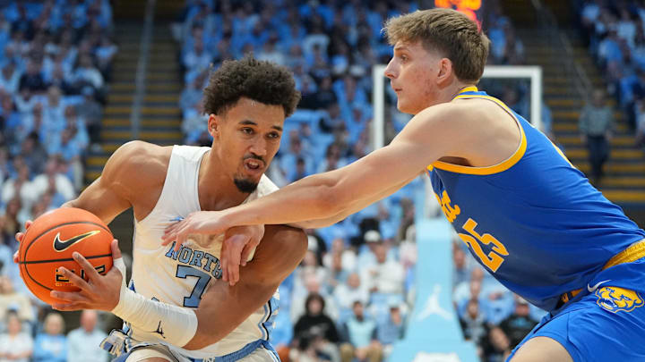 Feb 14, 2026; Chapel Hill, North Carolina, USA; North Carolina Tar Heels guard Seth Trimble (7) with the ball as Pittsburgh Panthers guard Nojus Indrusaitis (25) defends in the second half at Dean E. Smith Center. Mandatory Credit: Bob Donnan-Imagn Images