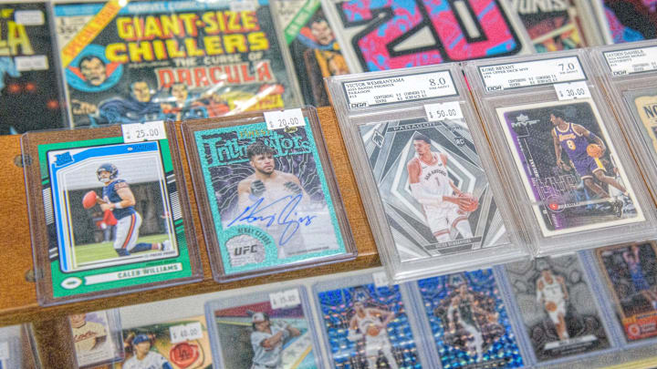 Rare sports cards, some graded for quality, sit in a display shelf at the new shop Stooges Comics & Collectibles in the Oak Cliff Park shopping center in Peoria.