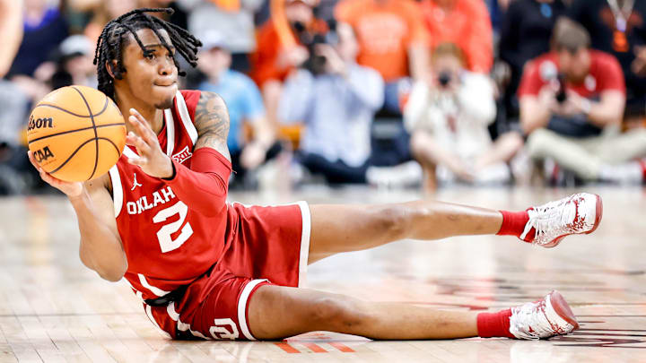 Oklahoma guard Javian McCollum (2) dives to the ground to pass the ball in the second half during an