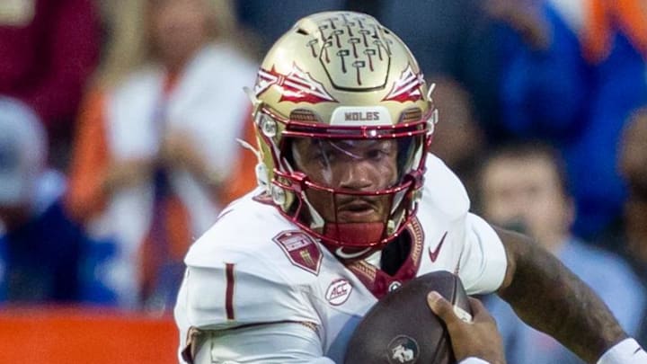 Nov 29, 2025; Gainesville, Florida, USA; Florida State Seminoles quarterback Tommy Castellanos (1) runs the ball during the first quarter against the Florida Gators at Ben Hill Griffin Stadium. Mandatory Credit: Bob Kupbens-Imagn Images