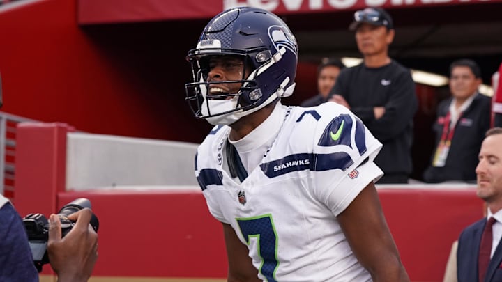 Nov 17, 2024; Santa Clara, California, USA; Seattle Seahawks quarterback Geno Smith (7) celebrates after scoring a rushing touchdown past San Francisco 49ers cornerback Isaac Yiadom (22) to win the game in the fourth quarter at Levi's Stadium.