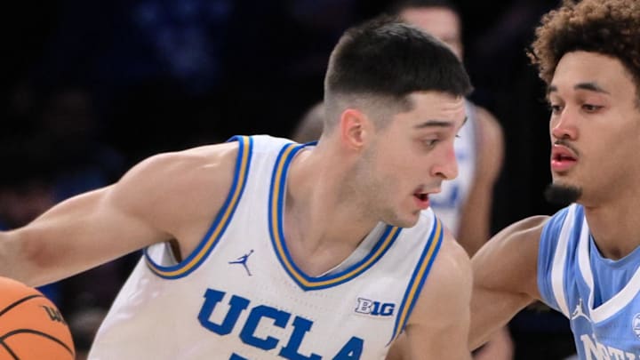 Dec 21, 2024; New York, NY, USA; UCLA Bruins guard Lazar Stefanovic (10) tries to get past North Carolina Tar Heels guard Seth Trimble (7) during the second half at Madison Square Garden. Mandatory Credit: John Jones-Imagn Images