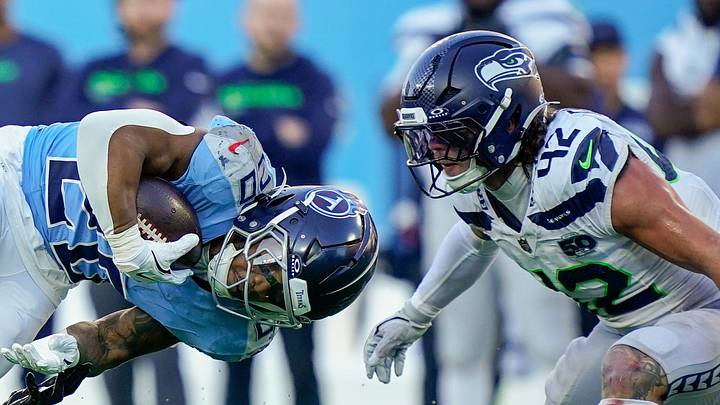 Tennessee Titans running back Tony Pollard is tackled by Seattle Seahawks cornerback Riq Woolen. Tennessee Titans running back Tony Pollard is tackled by Seattle Seahawks cornerback Riq Woolen.