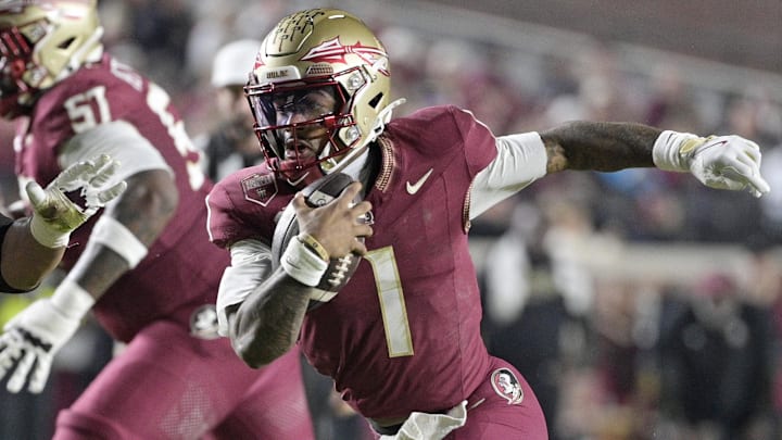 Nov 15, 2025; Tallahassee, Florida, USA; Florida State Seminoles quarterback Thomas Castellanos (1) runs the ball past Virginia Tech Hokies defensive lineman Kelvin Gilliam Jr. (22) during the first half at Doak S. Campbell Stadium. Mandatory Credit: Melina Myers-Imagn Images