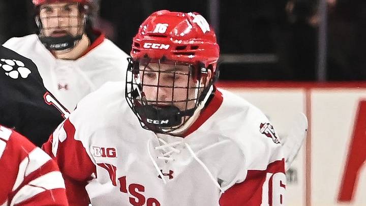 Wisconsin forward Jack Horbach (22) brings the puck up the ice with forward Tyson Dyck (16) following him against Northeastern during the second period of the championship game of the Kwik Trip Holiday Face-Off on Friday, December 29, 2023, at Fiserv Forum in Milwaukee, Wisconsin.