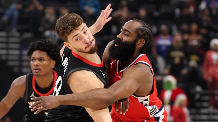 Dec 23, 2025; Inglewood, California, USA;  Los Angeles Clippers guard James Harden (1) passes the ball around Houston Rockets center Alperen Sengun (28) during the first quarter at Intuit Dome. Mandatory Credit: Kiyoshi Mio-Imagn Images