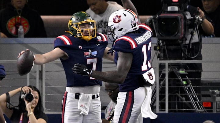 Jan 30, 2025; Arlington, TX, USA; East tight end Joshua Simon of South Carolina (86) and East quarterback Cam Miller of North Dakota State (7) and East tight end Rivaldo Fairweather of Auburn (13) celebrate after converting a two point conversion against the West during the first half at AT&T Stadium. Mandatory Credit: Jerome Miron-Imagn Images