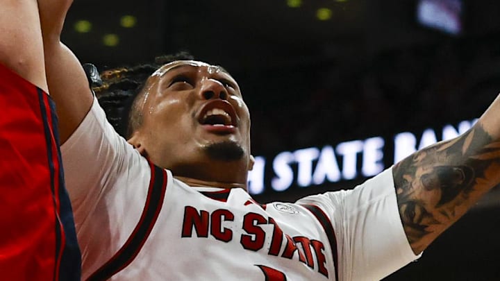 Dec 6, 2025; Raleigh, North Carolina, USA; NC State Wolfpack forward Darrion Williams (1) goes for a dunk past Liberty Flames forward Zach Cleveland (25) during the first half of the game at Lenovo Center. Mandatory Credit: Jaylynn Nash-Imagn Images Dec 6, 2025; Raleigh, North Carolina, USA; NC State Wolfpack forward Darrion Williams (1) goes for a dunk past Liberty Flames forward Zach Cleveland (25) during the first half of the game at Lenovo Center. Mandatory Credit: Jaylynn Nash-Imagn Images