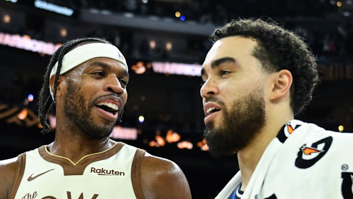 Golden State Warriors guard Buddy Hield talks with Orlando Magic guard Tyus Jones.