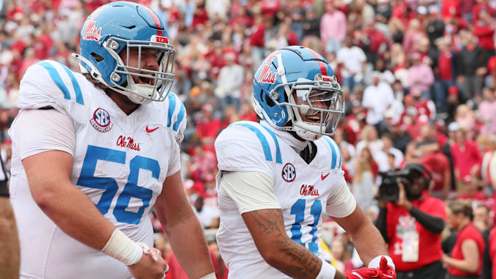 Ole Miss Rebels wide receiver Jordan Watkins (11) celebrates with offensive lineman Reece McIntyre (56) after catching one of his SEC record-tying five touchdowns against the Arkansas Razorbacks Saturday.
