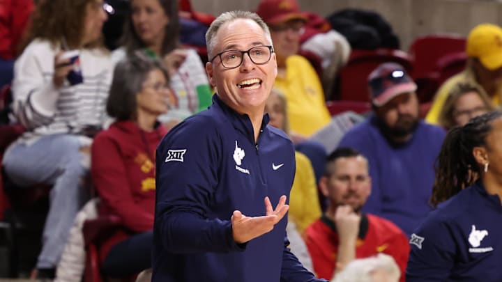 Jan 11, 2026; Ames, Iowa, USA; West Virginia Mountaineers head coach Mark Kellogg watches his team play the Iowa State Cyclones during the first half at James H. Hilton Coliseum. Mandatory Credit: Reese Strickland-Imagn Images