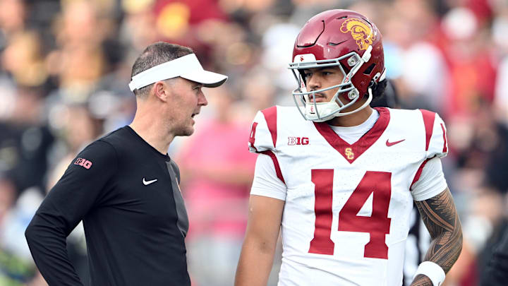 Sep 13, 2025; West Lafayette, Indiana, USA; Southern California Trojans quarterback Jayden Maiava (14) talks with Southern California Trojans head coach Lincoln Riley before the game against the Purdue Boilermakers at Ross-Ade Stadium. Sep 13, 2025; West Lafayette, Indiana, USA; Southern California Trojans quarterback Jayden Maiava (14) talks with Southern California Trojans head coach Lincoln Riley before the game against the Purdue Boilermakers at Ross-Ade Stadium.
