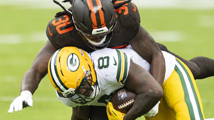 Cleveland Browns linebacker Devin Bush (30) tackles Green Bay Packers running back Josh Jacobs.