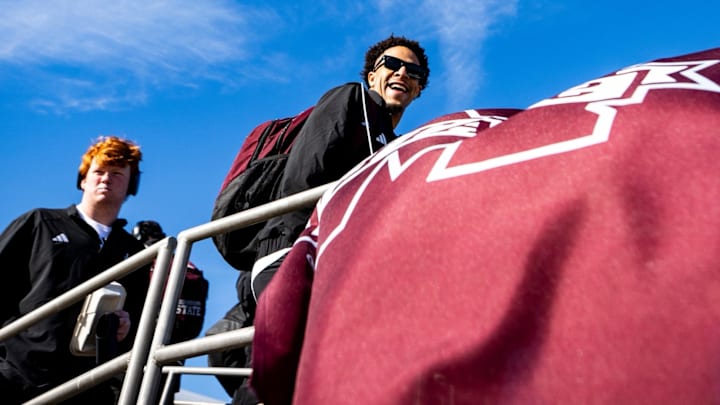 Mississippi State wide receiver Brenen Thompson smiles as he boards a plane bound for the Duke's Mayo Bowl.