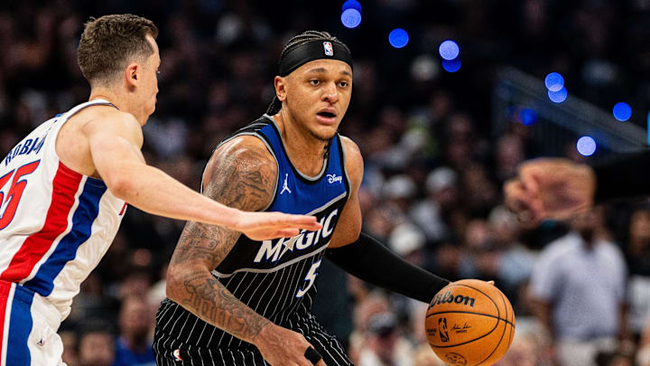 May 1, 2026; Orlando, Florida, USA; Orlando Magic forward Paolo Banchero (5) dribbles the ball against Detroit Pistons forward Duncan Robinson (55) in the fourth quarter during game six of the first round of the 2026 NBA Playoffs at Kia Center. Mandatory Credit: Jeremy Reper-Imagn Images