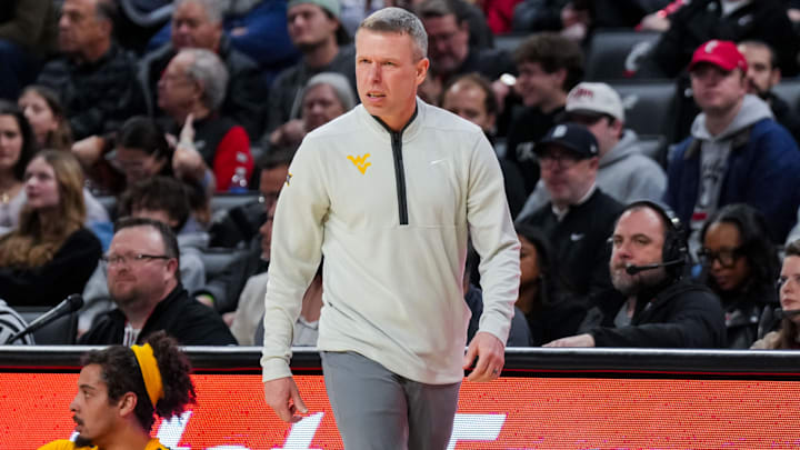 Feb 5, 2026; Cincinnati, Ohio, USA;  West Virginia Mountaineers head coach Ross Hodge works the sideline against the Cincinnati Bearcats in the first half at Fifth Third Arena. Mandatory Credit: Aaron Doster-Imagn Images