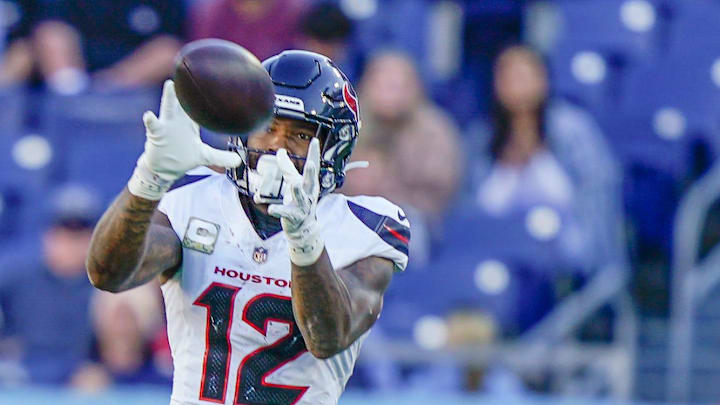 Houston Texans wide receiver Nico Collins receives a pass over Tennessee Titans cornerback Darrell Baker Jr. Houston Texans wide receiver Nico Collins receives a pass over Tennessee Titans cornerback Darrell Baker Jr.