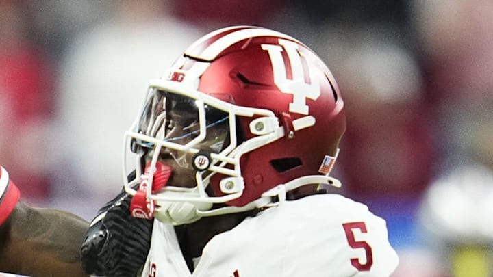 Ohio State Buckeyes wide receiver Jeremiah Smith shakes off Indiana Hoosiers defensive back D'Angelo Ponds.