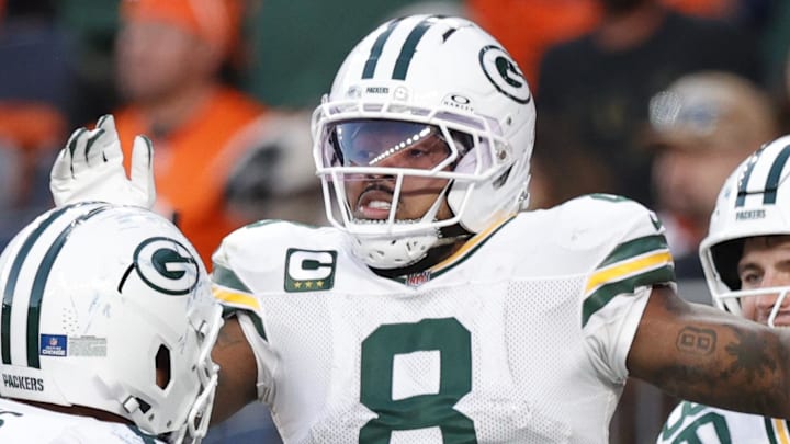 Green Bay Packers running back Josh Jacobs (8) celebrates his touchdown catch at Denver.
