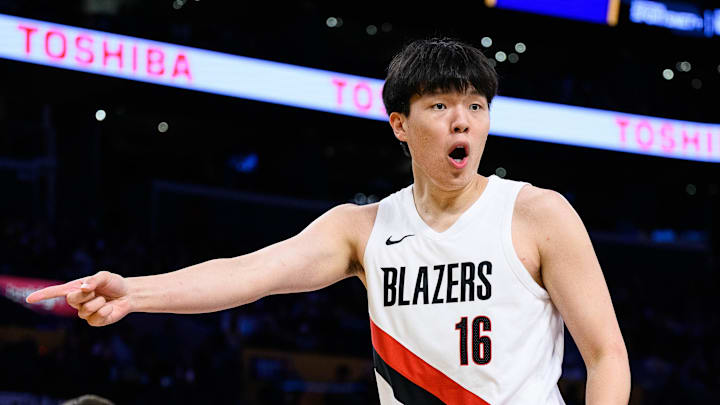 Oct 27, 2025; Los Angeles, California, USA; Portland Trail Blazers center Yang Hansen (16) reacts during the first half against the Los Angeles Lakers at Crypto.com Arena. Mandatory Credit: William Liang-Imagn Images