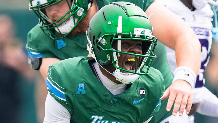 Aug 30, 2025; New Orleans, Louisiana, USA; Tulane Green Wave wide receiver Omari Hayes (1) reacts to catching a pass against Northwestern Wildcats defensive back Braden Turner (9) during the first half at Yulman Stadium.