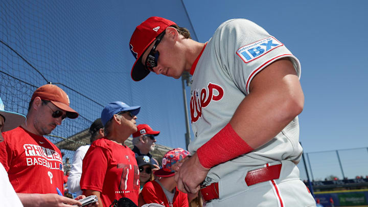 Mar 2, 2025; Dunedin, Florida, USA; Philadelphia Phillies infielder Aidan Miller (81) signs autographs for fans before a game against the Toronto Blue Jays during spring training at TD Ballpark. Mandatory Credit: Nathan Ray Seebeck-Imagn Images