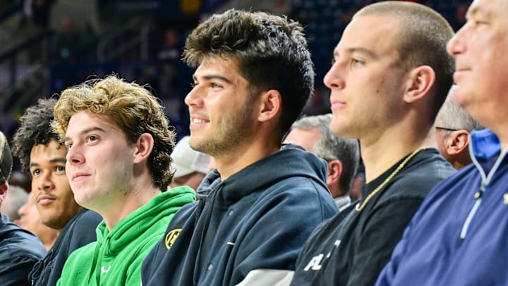 Nov 11, 2024; South Bend, Indiana, USA; Notre Dame football quarterbacks (from left to right) Riley Leonard, Kenny Minchey, Steve Angeli, Anthony Rezac and CJ Carr watch in the first half of the basketball game between the Notre Dame Fighting Irish and the Buffalo Bulls at the Purcell Pavilion. Nov 11, 2024; South Bend, Indiana, USA; Notre Dame football quarterbacks (from left to right) Riley Leonard, Kenny Minchey, Steve Angeli, Anthony Rezac and CJ Carr watch in the first half of the basketball game between the Notre Dame Fighting Irish and the Buffalo Bulls at the Purcell Pavilion.