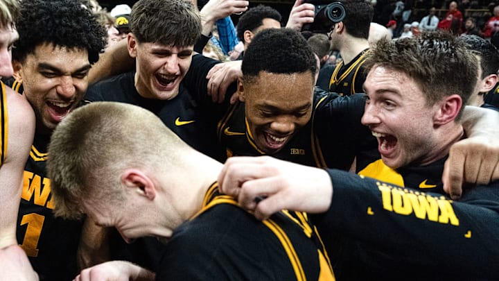 Iowa’s Cooper Koch (8), Kael Combs (11), Trey Thompson (20), Cam Manyawu (3) and Brendan Hausen (15) mob Bennett Stirtz (14) after the Hawkeyes defeated the Nebraska Cornhuskers 57-52 Feb. 17, 2026 at Carver-Hawkeye Arena in Iowa City, Iowa.