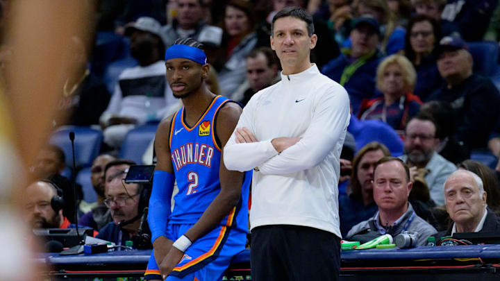 Dec 7, 2024; New Orleans, Louisiana, USA;  Oklahoma City Thunder head coach Mark Daigneault and Oklahoma City Thunder guard Shai Gilgeous-Alexander (2) watch the New Orleans Pelicans during the first half at Smoothie King Center. Mandatory Credit: Matthew Hinton-Imagn Images