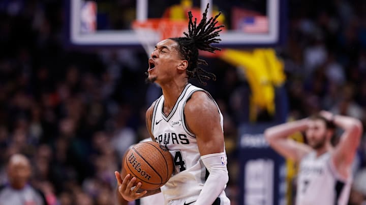 Nov 28, 2025; Denver, Colorado, USA; San Antonio Spurs guard Devin Vassell (24) reacts after a play in the fourth quarter against the Denver Nuggets at Ball Arena.