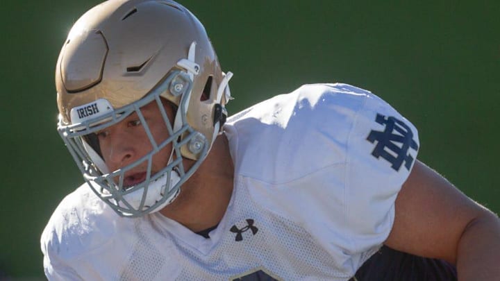 Notre Dame football player Howard Cross III runs a drill during practice 