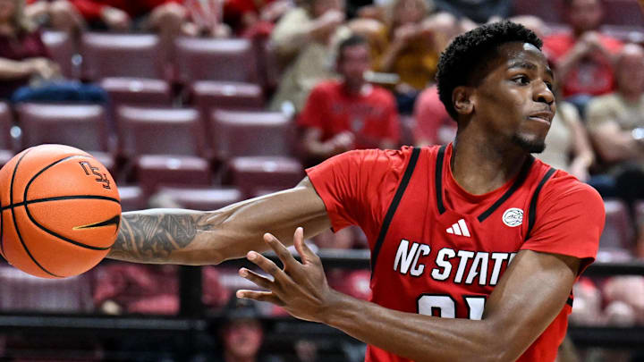 Jan 10, 2026; Tallahassee, Florida, USA; North Carolina State Wolfpack guard Terrance Arceneaux (21) passes the ball as Florida State Seminoles guard Kobe MaGee (5) looks on during the second half at Donald L. Tucker Center. Mandatory Credit: Melina Myers-Imagn Images Jan 10, 2026; Tallahassee, Florida, USA; North Carolina State Wolfpack guard Terrance Arceneaux (21) passes the ball as Florida State Seminoles guard Kobe MaGee (5) looks on during the second half at Donald L. Tucker Center. Mandatory Credit: Melina Myers-Imagn Images