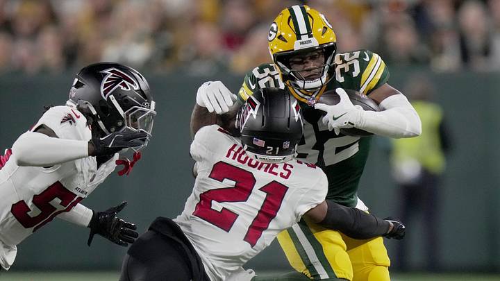Green Bay Packers running back Marshawn Lloyd  is tackled by Atlanta Falcons cornerback Mike Hughes 