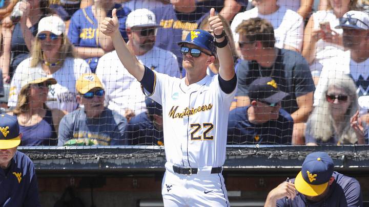 Jun 5, 2026; Morgantown, WV, USA; West Virginia Mountaineers head coach Steve Sabins gives a thumbs up to his team during the first inning against the Cal Poly Mustangs at Kendrick Family Ballpark. Mandatory Credit: Ben Queen-Imagn Images