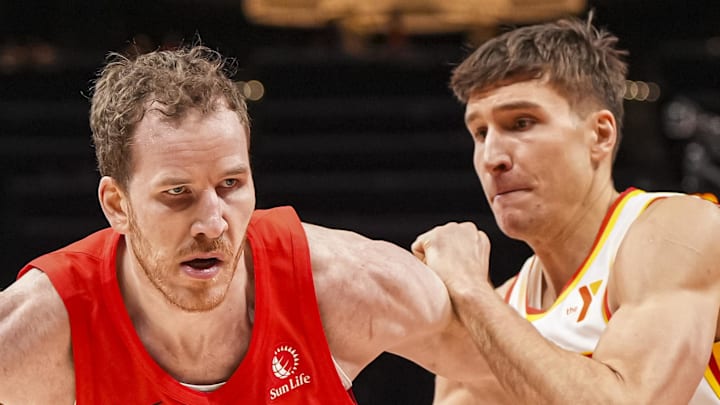 Toronto Raptors center Jakob Poeltl dribbles guarded by Atlanta Hawks guard Bogdan Bogdanovic. Toronto Raptors center Jakob Poeltl dribbles guarded by Atlanta Hawks guard Bogdan Bogdanovic.