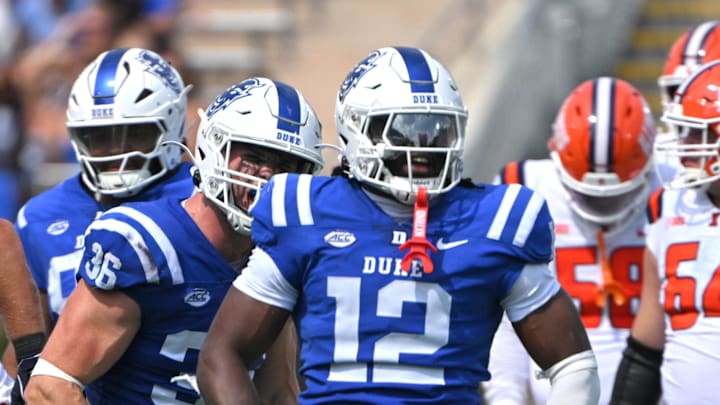 Sep 6, 2025; Durham, North Carolina, USA; Duke Blue Devils linebacker Tre Freeman (12) celebrates a tackle against Illinois Fighting Illini defensive back Torrie Cox Jr. (5) during the third quarter at Wallace Wade Stadium. Mandatory Credit: Zachary Taft-Imagn Images Sep 6, 2025; Durham, North Carolina, USA; Duke Blue Devils linebacker Tre Freeman (12) celebrates a tackle against Illinois Fighting Illini defensive back Torrie Cox Jr. (5) during the third quarter at Wallace Wade Stadium. Mandatory Credit: Zachary Taft-Imagn Images