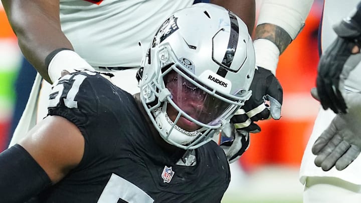 Jan 7, 2024; Paradise, Nevada, USA; Denver Broncos quarterback Jarrett Stidham (4) reacts after being knocked down by Las Vegas Raiders defensive end Malcolm Koonce (51) during the second quarter at Allegiant Stadium. Mandatory Credit: Stephen R. Sylvanie-Imagn Images