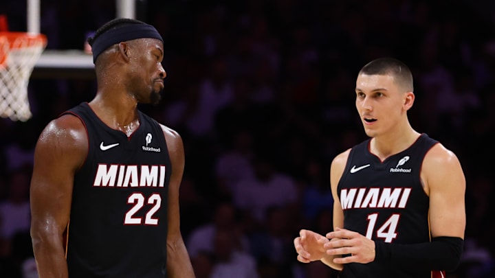 Oct 30, 2024; Miami, Florida, USA; Miami Heat forward Jimmy Butler (22) and guard Tyler Herro (14) talk on the court against the New York Knicks during the second quarter at Kaseya Center. Mandatory Credit: Sam Navarro-Imagn Images