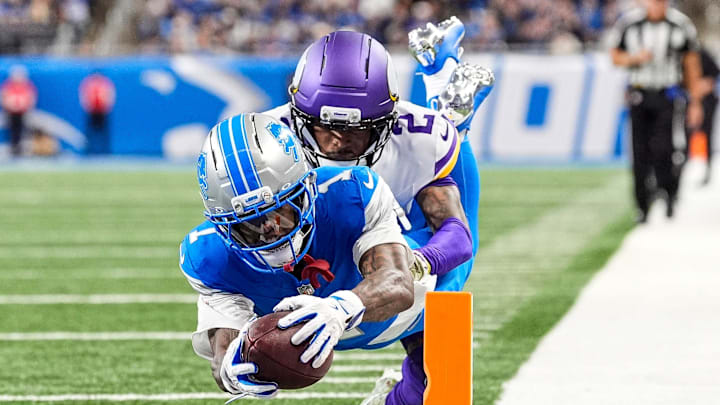 Detroit Lions wide receiver Jameson Williams (1) dives for a touchdown against Minnesota Vikings cornerback Isaiah Rodgers (2) during the second half at Ford Field in Detroit on Sunday, November 2, 2025.