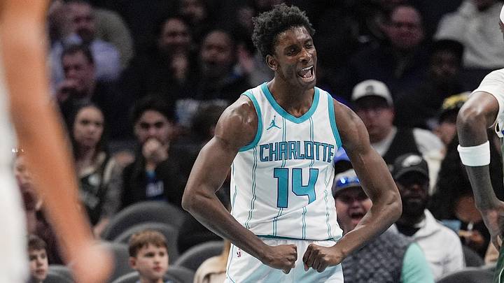 Feb 5, 2025; Charlotte, North Carolina, USA; Charlotte Hornets forward Moussa Diabate (14) reacts to his three point play against the Milwaukee Bucks during the second quarter at Spectrum Center. Mandatory Credit: Jim Dedmon-Imagn Images