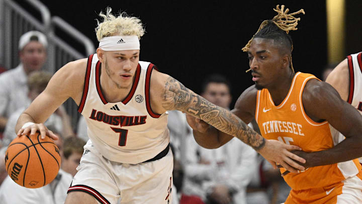 Nov 9, 2024; Louisville, Kentucky, USA;  Louisville Cardinals forward Kasean Pryor (7) dribbles against Tennessee Volunteers guard Jahmai Mashack (15) during the first half at KFC Yum! Center. Mandatory Credit: Jamie Rhodes-Imagn Images