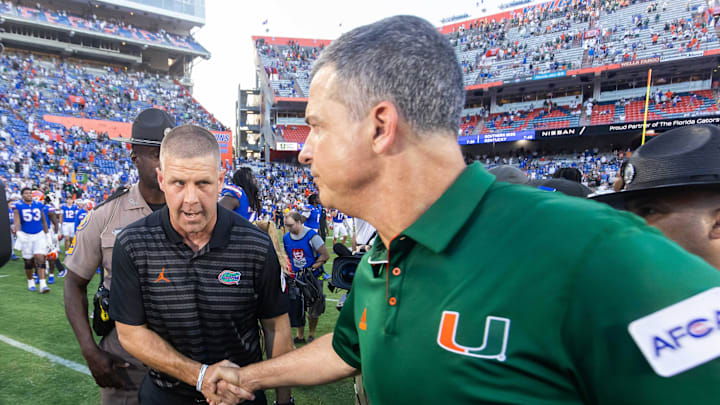 Florida Gators head coach Billy Napier, left shakes hands with Miami Hurricanes head coach Mario Cristobal after the Hurricanes defeated the Gators during the season opener at Ben Hill Griffin Stadium in Gainesville, FL on Saturday, August 31, 2024 against the University of Miami Hurricanes. The Hurricanes defeated the Gators 41-17. [Doug Engle/Gainesville Sun]
