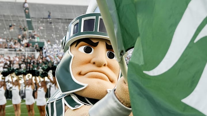 Sep 13, 2025; East Lansing, Michigan, USA; Sparty, the Michigan State mascot waves a Michigan State flag following a victory over Youngstown State at Spartan Stadium. Sep 13, 2025; East Lansing, Michigan, USA; Sparty, the Michigan State mascot waves a Michigan State flag following a victory over Youngstown State at Spartan Stadium.