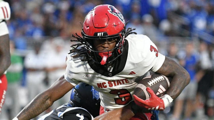 Sep 20, 2025; Durham, North Carolina, USA;  North Carolina State Wolfpack running back Hollywood Smothers (3) is tackled by Duke Blue Devils running back Anderson Castle (4) during the fourth quarter  at Wallace Wade Stadium. Mandatory Credit: Zachary Taft-Imagn Images
