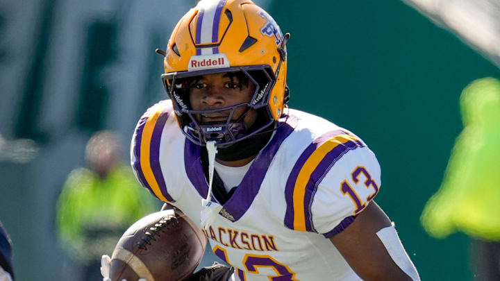 Jackson's Ezavier Crowell (13) tries to evade a tackle by Cherokee County's Tyson Wood (8) at Protective Stadium in the AHSAA 4A State Championship game.