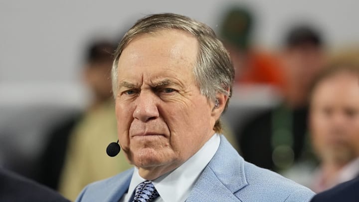 Jan 19, 2026; Miami Gardens, FL, USA; TV analyst Bill Belichick watches the Miami Hurricanes play the Indiana Hoosiers during the first half of the College Football Playoff National Championship game at Hard Rock Stadium. Mandatory Credit: Kirby Lee-Imagn Images