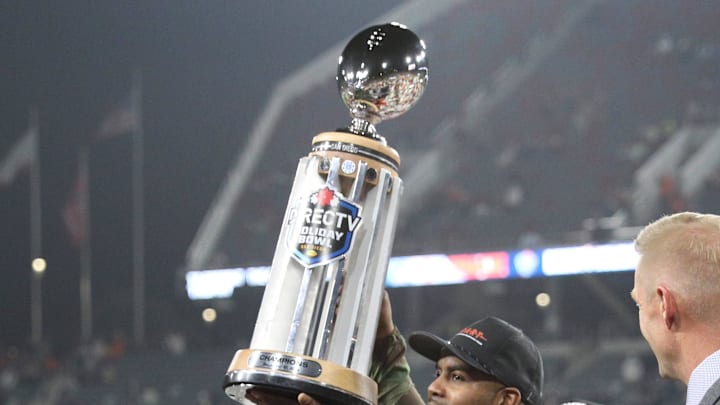 Dec 27, 2024; San Diego, CA, USA;  Syracuse Orange head coach Fran Brown raises the Holiday Bowl trophy after defeating the Washington State Cougars after the game at Snapdragon Stadium. Mandatory Credit: Abe Arredondo-Imagn Images