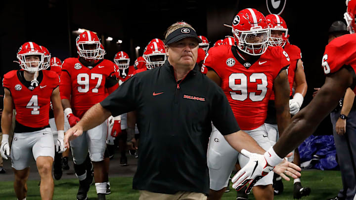 Georgia coach Kirby Smart leads his team onto the field for warm ups before the start of the NCAA Aflac Kickoff Game in Atlanta, on Saturday, Aug. 31, 2024.