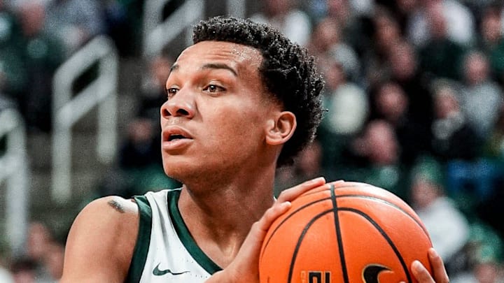 Michigan State guard Divine Ugochukwu (99) looks to pass the ball against Indiana forward Nick Dorn (7) during the first half at Breslin Center in East Lansing on Tuesday, Jan. 13, 2026.