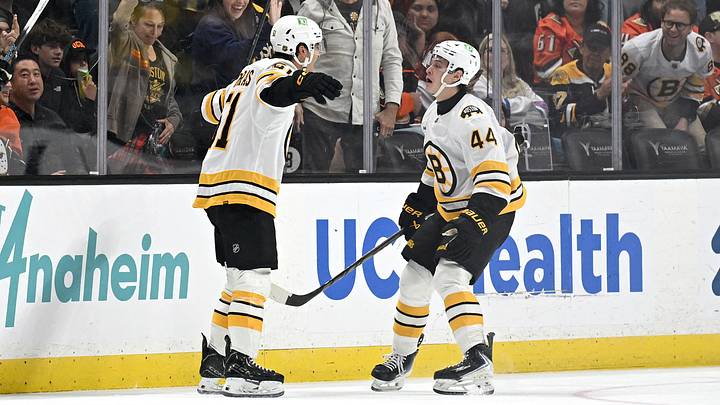 Oct 16, 2026; Anaheim, California, USA;  Boston Bruins center Matthew Poitras (51) celebrates with center James Hagens (44) after scoring a goal against the Anaheim Ducks during the third period at Honda Center.  Mandatory Credit: Griffin Hooper-Imagn Images